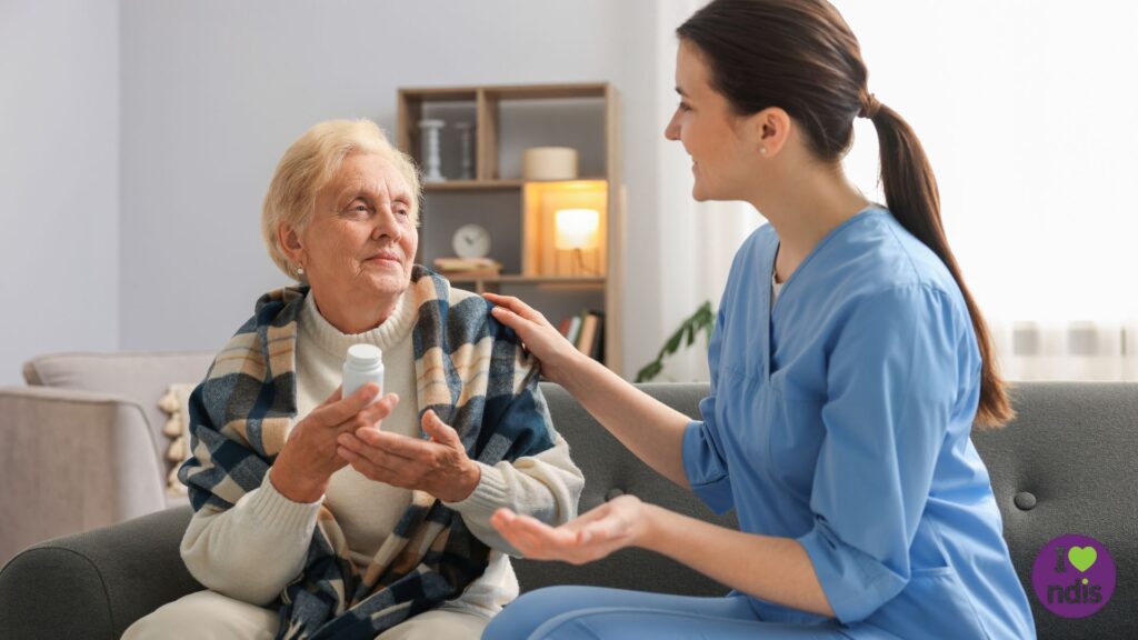 Support Worker helping elderly woman at home in taking her medicines